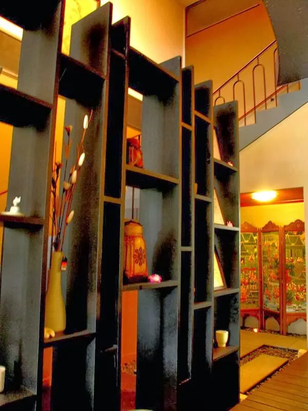 Black lattice room divider in decorated back room