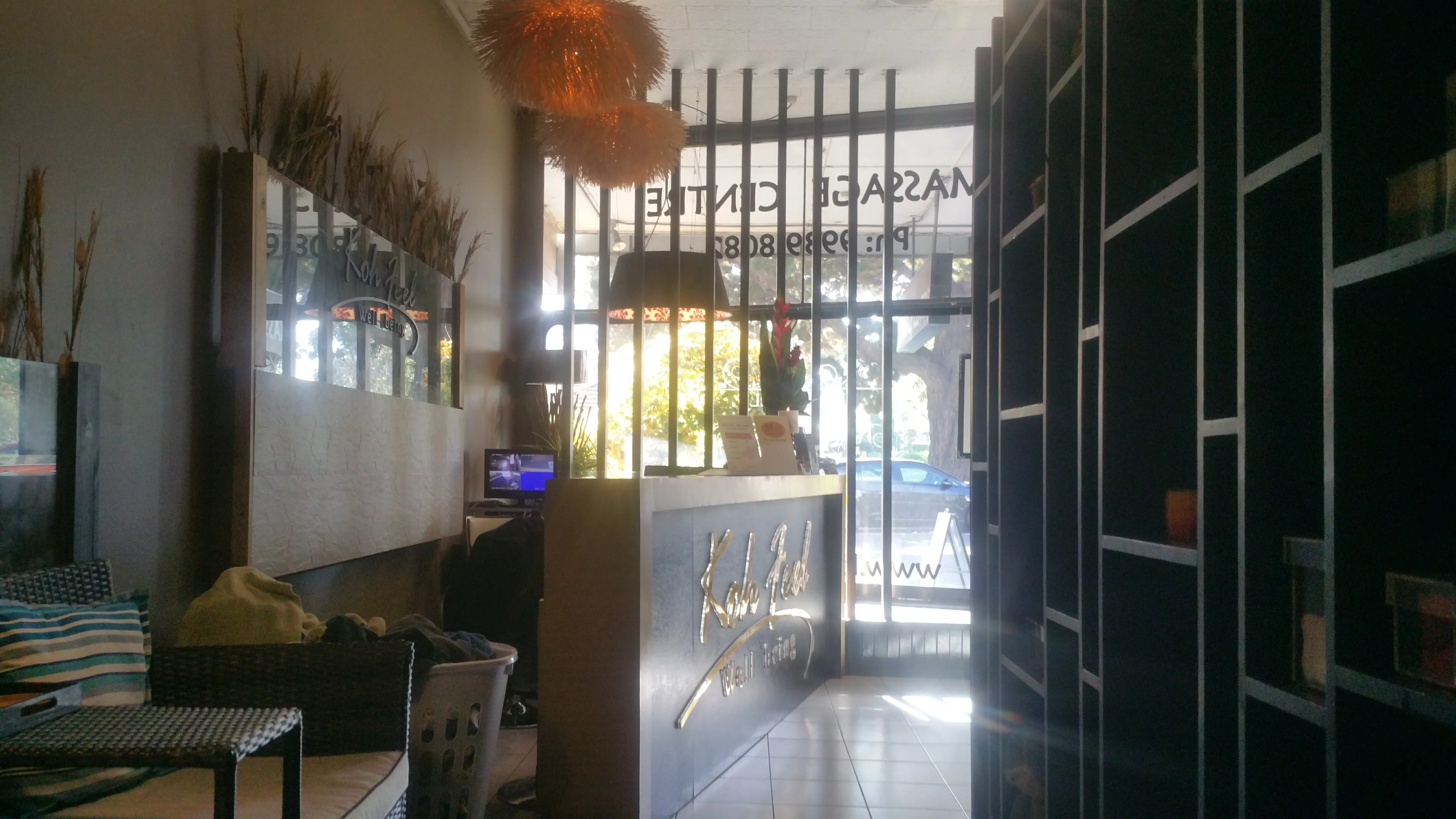 Reception lounge with rattan chairs and gold desk sign