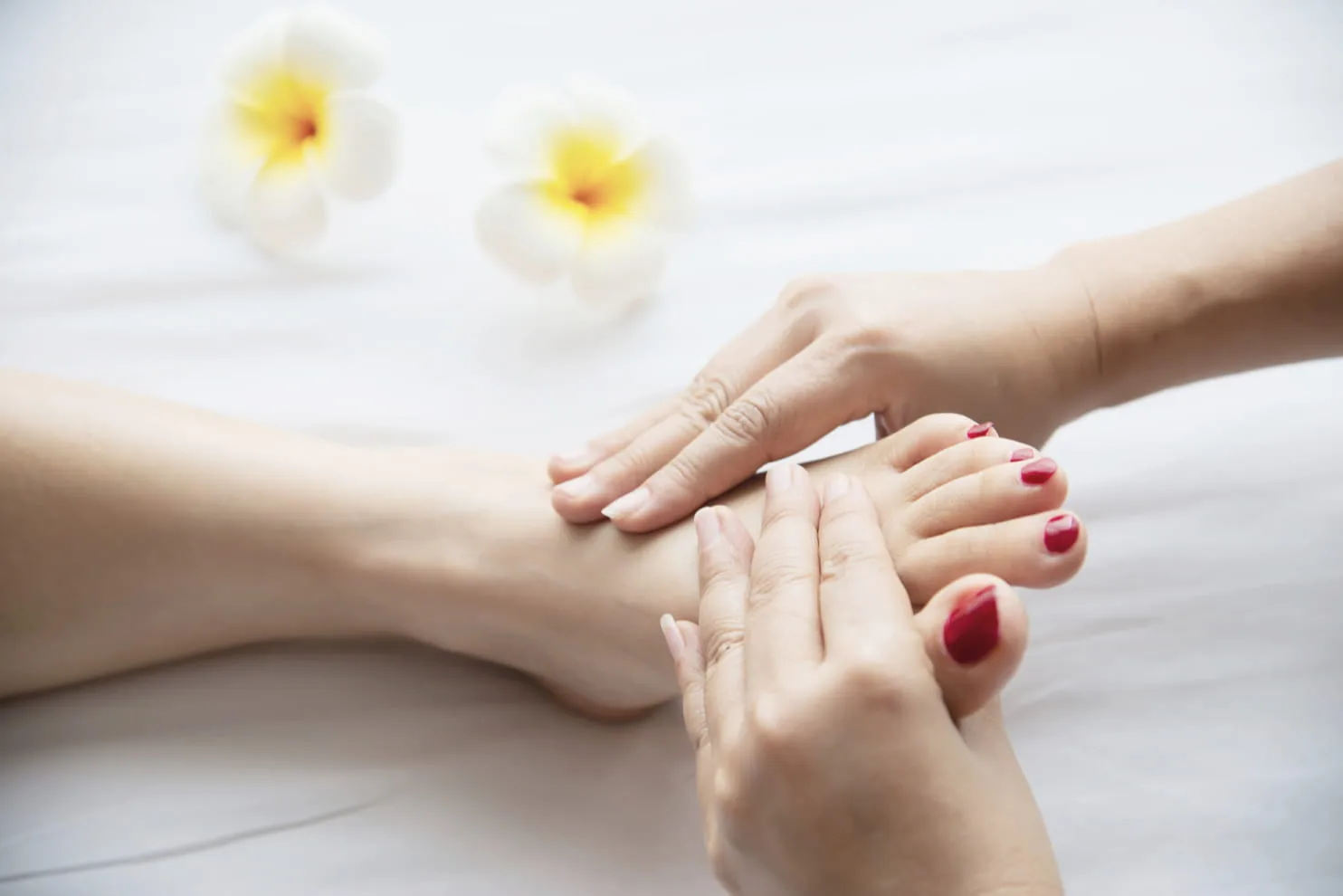 Foot reflexology treatment with frangipani