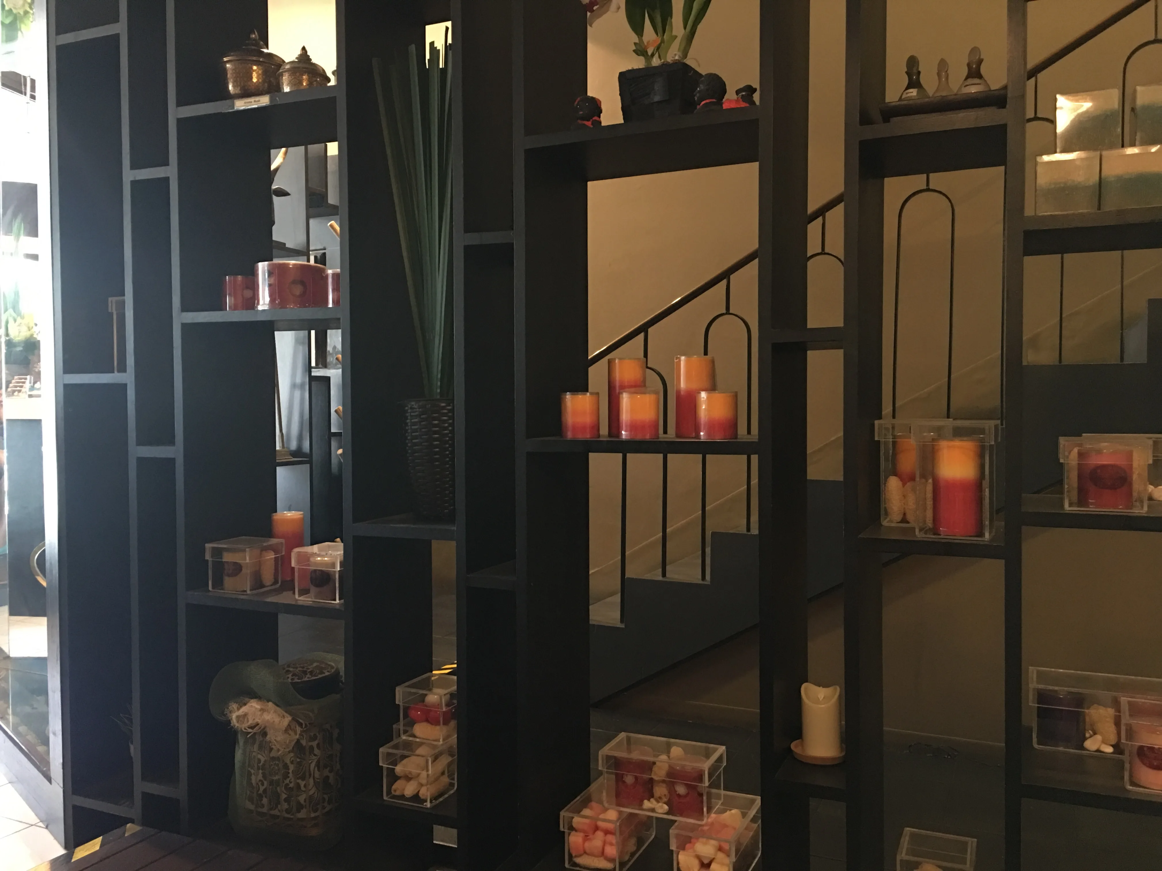Candlelit interior with black lattice shelving